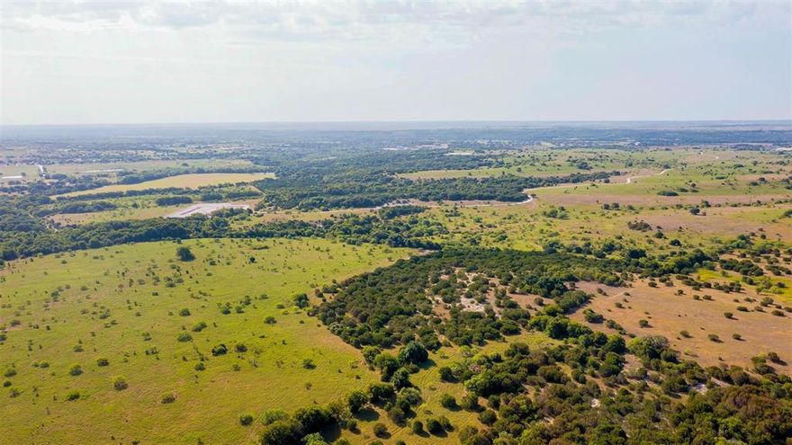 Gorgeous raw land in Aledo ISD with large trees throughout and Bear Creek running through it. This land in several spots has some amazing views to downtown Fort Worth that are ideal for a home site. This land could be someone's homesite and ranch or a development. This property has a creek and county road and US Hwy frontage. This is a great opportunity to own part of a beautiful family ranch. Opportunities for amazing properties like this one don't come along often.