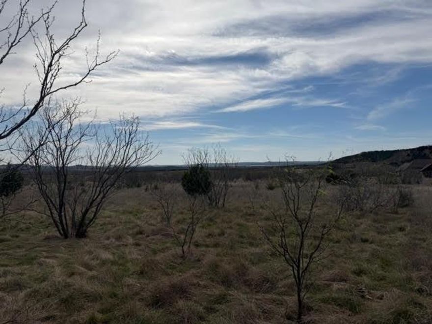 Private and secluded five acre lot backs up to a cattle ranch and has view of Possum Kingdom Lake from two directions. Lot is mostly level with a slight elevation to the south offering the great views. Street is a culdesac with little traffic. The Hills is a very social neighborhood with excellent neighbors and lots of ameniities. Lot ownerrship permits the use of all of the amenities including; clubhouse with pool, fitness center, and game room, boat storage area, lakeside cabin with restrooms and covered patio, boat ramp, community dock, fishing, and miles of private roads behid the gates.