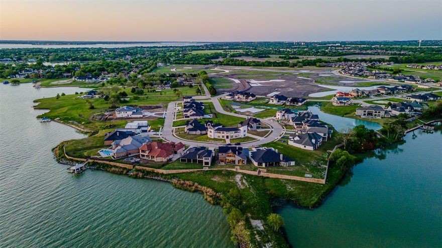 Luxury Lakefront New-Construction Home, Private Peninsula on Lake Ray Hubbard, Rockwall–Heath 
Experience luxury waterfront living in this brand-new modern custom home located on a private peninsula on Lake Ray Hubbard, offering unparalleled shoreline views and potential space for your future private boathouse. This rare opportunity combines architectural sophistication, premier craftsmanship, and breathtaking true lakefront access in the highly desirable Rockwall–Heath luxury corridor.
Designed by elite custom home builders in Rockwall, this residence features exquisite curated finishes including Ivory Macabus quartzite countertops, authentic European oak wood floors, large-format slate tile, designer lighting, and soaring 12-foot ceilings throughout.
The expansive open-concept living, dining, and kitchen area showcases dramatic 12-foot sliding iron doors and floor-to-ceiling windows, framing unobstructed panoramic water views — the perfect backdrop for luxury lakefront living and entertaining.
Primary Suite with Waterfront Views
Wake up to peaceful lake scenery from the luxurious primary suite complete with:
Cathedral ceiling and panoramic lakefront windows
Spa-inspired ensuite with walk-in dual rain shower
Freestanding soaking tub
Quartz countertops, dual vanities
Custom designer closet system
Spacious second-Level Entertainment Loft functions as a media room + game room combo, featuring glass sliding doors opening to a private balcony — the ultimate spot to enjoy sunset views and watch evening sailing regattas glide across Lake Ray Hubbard.
Direct Lake Ray Hubbard waterfront — true lakefront
Private peninsula lot with shoreline for future boathouse
Luxury new construction modern architectural design
Premium bespoke materials and designer finishes
12’ ceilings & floor-to-ceiling iron + glass
Spa-quality primary retreat with lake views
Entertainment loft + balcony overlooking the water
Rockwall–Heath luxury home market location