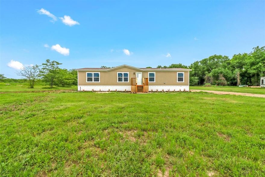 Seller says to bring all offers! Motivated seller! Tired of living in the city? Looking for land? Welcome to your new home on over 5 acres of land just minutes from Lake Tawakoni!
Large living area open to the kitchen and dining area. Large master suite with soaking tub and walk in closet. Three additional bedrooms and a bath are located on the other side of the home. Care-free laminate flooring throughout the home. Utility room with storage. Nice back porch just off the dining room looks out over the acreage. Great place to enjoy your morning coffee or to relax in the evening. Ample room to build a shop or barn. Make your appointment to see this beauty today!