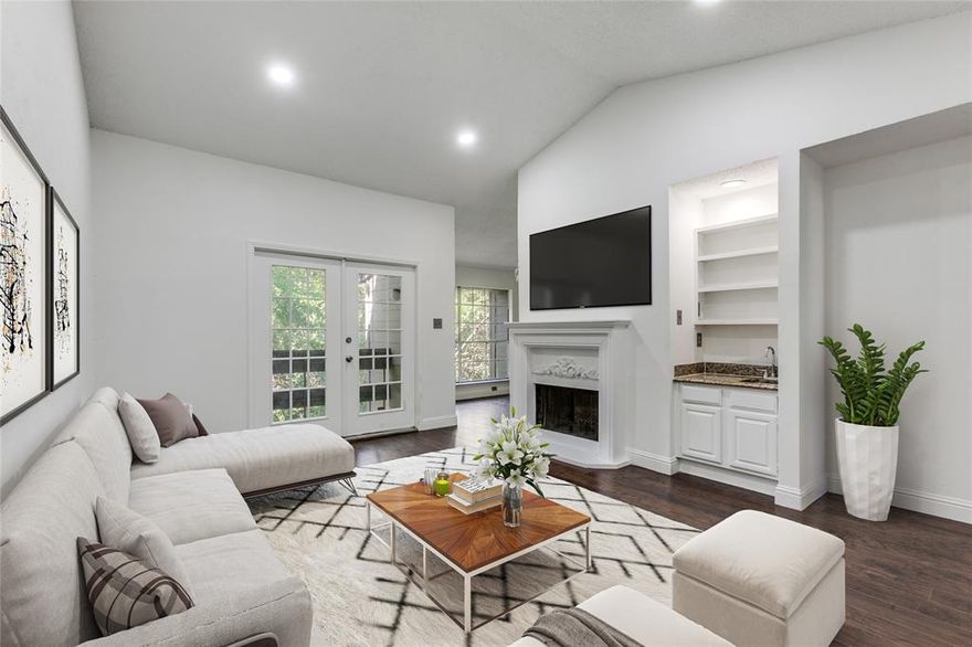 This condo is a Lake Highlands gem, and it's ready for you to call it your new home sweet home! It is beautifully remodeled and offers all of the natural lighting you can dream of. The vaulted ceilings, unique fireplace, gorgeous windows, views of the greenery and creek, and luxury lighting features all make it a must see! The full size washer and dryer, refrigerator and microwave were all just newly placed in the home for you too! Plus there is a built in wine cooler and wet bar with built in shelving, perfect for entertaining. Two nicely sized bedrooms and one oversized bathroom, with two sinks. NEW HVAC! This is a prime location, situated close to highways, shops, restaurants, parks, gyms and more! Make sure to notice the gorgeous community pool, landscaping, and assigned covered parking. Welcome home! (virtually staged)