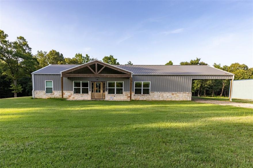East Texas - Hopkins County complete package! Sitting on 15+ acres this 3BR-2.5BA  charmer has everything you're looking for. Built in 2021, the home features spray insulation throughout, gutters, attached carport, concrete floors, granite counters, custom cabinets, walk-in pantry, SS appliances, primary bedroom split, huge walk-in closet with built-in dresser. Solar panels help minimize the electricity bill, and there's abundant storage throughout. The property also includes a 40x50 shop with living quarters, originally built in 2019 and updated in 2024. Inside you'll find a kitchenette, bedroom with walk-in closet, bathroom with large walk-in shower, air conditioning & sprayed insulation. There's ample space foe equipment such as 4-wheelers, tractor or riding mowers, plus Priefert stalls ready for your livestock. Additional highlights include a 50-amp camper plug-in with sewer connection and covered parking spot for your RV. The land offers approximately 5 acres of front pasture, woods in the back, a creek, and abundant wildlife including deer and hogs. This property truly has it all- home, shop, pasture, and woods. Don't Wait, Call Today!