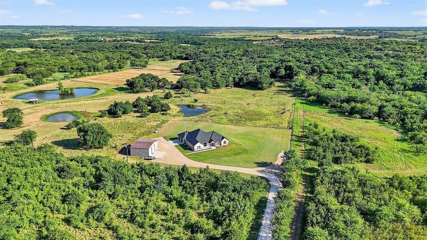 Welcome to 2340 Wright Rd. in Sherman, TX — a rare opportunity to own 15.053 acres of ag-exempt, wildlife-rich land paired with a beautifully maintained 4-bedroom, 2-bath brick home offering 2,113 sqft of comfortable living space. Tucked away in a peaceful country setting less than a mile from the Hagerman National Wildlife Refuge, this property is a true hunter’s paradise, frequented by wild deer and turkey, and known for producing monster bucks. Inside, the home features a spacious open layout with abundant natural light, a large living area, and a well-appointed kitchen perfect for gathering and entertaining. The split-bedroom design offers privacy, with a generous primary suite and three additional bedrooms for family or guests. Step outside and you’ll find everything you need to live the Texas country lifestyle. A heated and cooled, spray foam insulated shop with roll-up doors provides the ultimate workspace or storage for toys and tools. The insulated well house is conveniently located within the shop for added protection and ease of access. A pond adds to the charm and functionality of the land, while open pastures and trees offer a perfect mix of beauty and usability. Whether you're dreaming of a peaceful homestead, a recreational getaway, or a hunting retreat, this property checks all the boxes. Don't miss your chance to own a slice of country heaven at 2340 Wright Rd.—schedule your showing today!