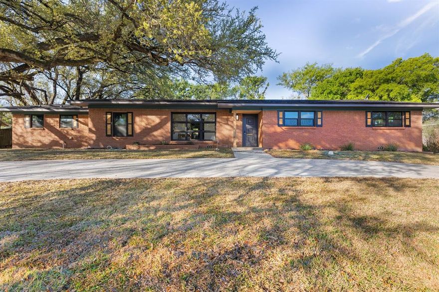 Welcome to this beautifully remodeled 4-bedroom, 3-bath home in the heart of Central Waco. From the moment you arrive, the circular drive creates an inviting first impression, while the extended driveway provides ample additional parking and easy backyard access.

Inside, you’ll find a bright, open-concept layout centered around a cozy wood-burning fireplace—perfect for gathering and relaxing. Large windows fill the living space with natural light, creating a warm and welcoming atmosphere.

The kitchen is designed for both everyday living and entertaining, featuring a gas range, generous counter space, and abundant storage. Adjacent to the kitchen are both a formal dining area and a casual breakfast nook, providing flexibility for any occasion.

The private primary suite is thoughtfully separated from the other bedrooms, creating a peaceful retreat. Three additional bedrooms are spacious and versatile, ideal for family, guests, or hobbies. A dedicated office just off the living area provides a convenient work-from-home setup.

This home blends comfort, functionality, and style—ready for you to move in and make it your own.