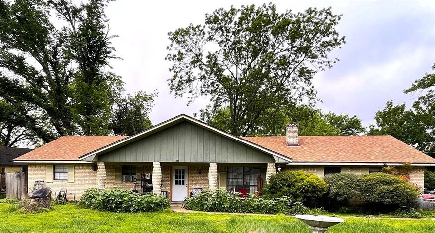 Noted for its distinctive spiral brick columns, this 3 bedroom, 2 bathroom Brick home offers practical updates and plenty of outdoor space on a prominent corner lot.  All-electric setup with a newer roof and updated meter box (both approx. 4 years old per seller).  The massive wood burning fireplace is the focal point of the living room accented by a cathedral ceiling.  All bedrooms are off a central hall and the primary bedroom has an ensuite bath.  The kitchen underwent a full remodel in 2013 including cabinetry, and the hall bathroom has been updated with classic subway tile & brushed nickel plumbing fixtures.  The property is fully enclosed with front and back fencing, featuring a covered back porch for outdoor shade.  A large laundry room with plenty of storage space leads to the attached 2-car garage with side entry.