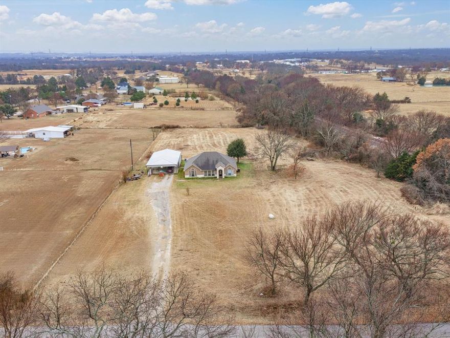 Welcome to your peaceful retreat outside city limits, in the heart of Decatur! This beautifully maintained 3-bedroom, 2-bath brick home sits on 3 spacious acres, partially fenced and perfect for outdoor enjoyment, pets, or future projects. Step inside to a warm and inviting open-concept layout featuring a large living room, kitchen, and dining area—ideal for entertaining family and friends. The kitchen boasts ample counter and cabinet space, sleek stainless steel electric appliances, and a generous walk-in pantry that offers all the storage you could need. The spacious primary suite is a true retreat, featuring a luxurious ensuite with a soaking tub, separate walk-in shower, and a large walk-in closet. Enjoy the privacy of a split-bedroom floor plan with two additional bedrooms and a full bathroom situated on the opposite side of the home.You’ll love the oversized laundry room, complete with tile floors, built-in cabinets, and space for a full-size washer and dryer. This is country living at its best—peaceful, private, and just a short drive to all that Decatur has to offer. Don’t miss your chance to make this beautiful home your own!