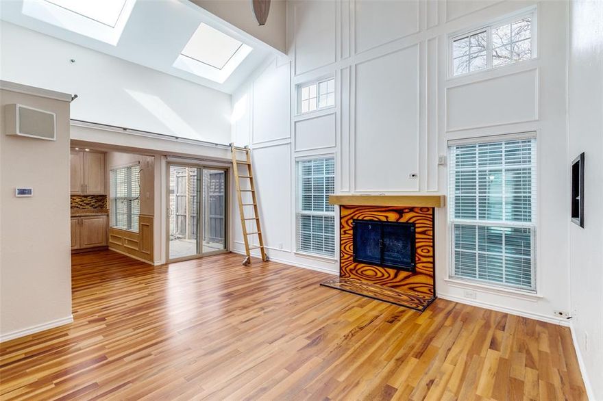 Located in Bryan Place just east of Downtown, this two story home places dining, retail, trails, and entertainment within minutes while still offering the feel of a neighborhood setting.

Inside, vaulted ceilings and skylights create impressive vertical volume in the main living area. Hardwood floors run throughout the main level, anchored by a wood burning fireplace. Built in shelving, a plant ledge detail, and an integrated Sonos sound system add character and function. Updated windows and sliding glass doors bring in natural light and open to the backyard.

The kitchen has been thoughtfully remodeled with granite counters, glass tile backsplash, stainless LG appliances including a double oven range, soft close cabinetry, built in wine storage, and a full size utility room nearby. The dining area overlooks the flagstone patio, creating easy indoor outdoor flow.

A dedicated downstairs workstation provides defined work from home space without sacrificing the second bedroom. The split bedroom layout includes a main level bedroom and full bath that works well for guests or flexible use. Upstairs, the primary suite offers privacy, custom closet systems, and an updated bath featuring a glass enclosed shower with multiple shower heads.

Outside, a pergola covered patio and fenced yard offer space to relax or entertain with minimal upkeep. The home also includes a sprinkler system, attached garage, and EV charging station.

Convenient to Downtown, Baylor, Deep Ellum, Uptown, Greenville Avenue, Knox Henderson, and White Rock Lake, this location supports a highly walkable lifestyle with restaurants, bars, coffee shops, and retail just steps away. Residents also enjoy access to the Bryan Place Swimming Pool Association, a private members only neighborhood pool offering a peaceful place to swim and unwind.

Live close to everything Dallas has to offer while enjoying the comfort of your own private retreat.