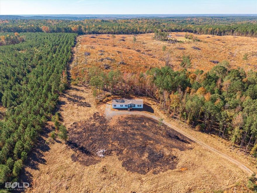 This stunning 2023 custom-built home offers 2,200 square feet of modern living space set on nearly nine acres of peaceful countryside. With four spacious bedrooms and three beautifully designed bathrooms, this brand-new residence blends comfort and style throughout. The remote owners suite provides a private retreat with a generous walk-in closet, a luxurious upgraded walk-in shower, and a double vanity. Three additional bedrooms, three of which can easily accommodate queen-size beds, ensure plenty of space for family or guests. Built with quality and efficiency in mind, the home features a new HVAC system, septic, and well. Enjoy the tranquility of wide-open acreage while still experiencing the convenience of a thoughtfully designed modern home.