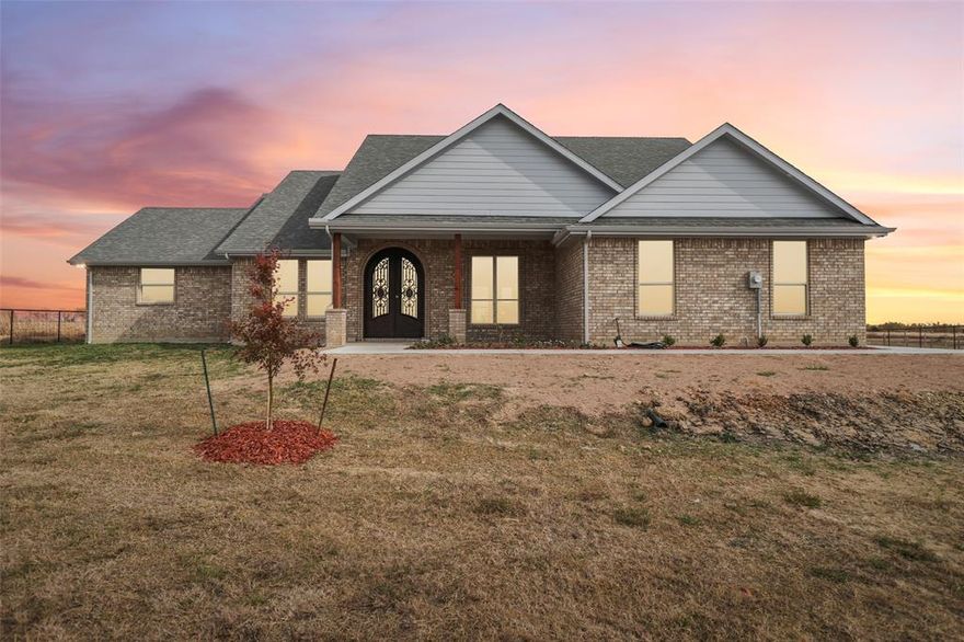 Experience peaceful country living in this brand-new 2025 custom home on over 1 acre! This 3 bed, 3 full bath home features a grand entrance with oversized iron French doors that lead you into a seamless open floor plan. Enjoy a cozy double-sided fireplace between the living room and primary suite with soaring 12ft ceilings, all 3 bathrooms offer stepless walk-in showers, custom-built cabinets throughout including the chefs kitchen with interior cabinet lighting. Custom LED exterior lighting, cedar garage door, and 2” metal tubing fencing add charm and security. An electric front security gate is being installed, and the concrete driveway and walkway will be completed by August. Relax on the covered patio or front porch and take in the surrounding wildlife—perfect for those seeking a quiet country lifestyle just outside the city. Move in ready August 2025