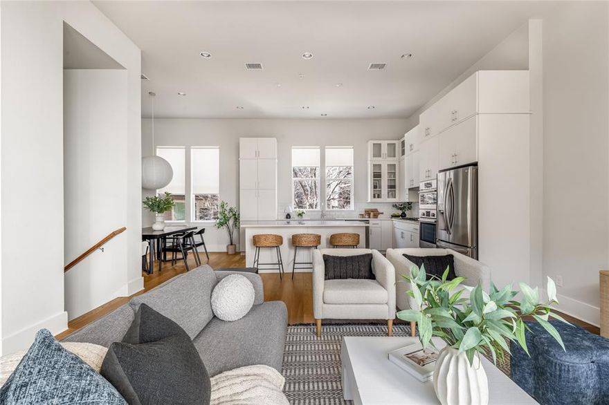 Welcome to this stunning end unit townhome in a prime location of a gated community near Bishop Arts! The first floor features a guest bedroom and attached private yard fitted with turf. The second floor has 14' ceilings, a spacious kitchen with ample storage, high end appliances, and a wine fridge built into the large kitchen island. The dining room and living room have dedicated spaces, yet still contribute the open concept design. Floor to ceiling sliding glass doors give an indoor outdoor feel to the space. The third floor has a second guest bedroom with an ensuite bath before you reach the massive primary bedroom with two oversized walk-in closets, high ceilings, and fantastic natural light. The spa like primary bath has two vanities, a soaking tub, and more storage. A laundry room and linen closet are also located on the third floor. A beautiful community pool is just steps away! Don't miss the opportunity to make this home your own.