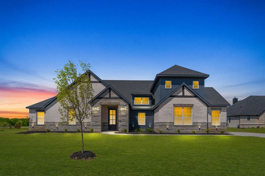 Modern country living at its finest! This newly built home sits on a spacious one-acre lot and features a bold gray stone and brick exterior with a sleek black roof. Inside, 10 ft ceilings and natural light enhance the open layout. A private office with French doors is conveniently located off the foyer, while the open-concept living and kitchen area features bold design elements, statement pendant lighting, and a copper farmhouse sink centered on the island. The primary suite offers a spa-like ensuite with gold finishes and a custom walk-in closet, and porcelain ceramic floorings. All bedrooms include walk-in closets and ceiling fans. A perfect blend of rural charm and modern luxury. An added bonus—a spacious upstairs game room, thoughtfully designed with no wasted space. Relax on the back patio and enjoy the serene nature that surrounds you.