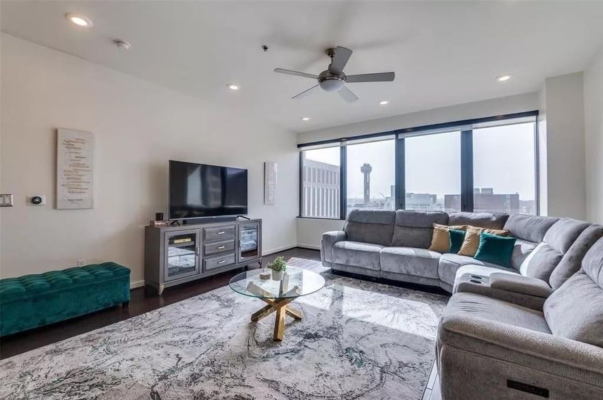 OPEN HOUSE ALERT 3-14-2026 from 1-3PM! 3.5% ASSUMABLE INTEREST RATE AVAILABLE. Why settle for today's higher rates when you can step into a 3.5% mortgage? Qualified buyers may assume the seller's existing loan and potentially save hundreds per month! Experience Breathtaking Sunsets in the Heart of Downtown Dallas. A picturesque moment in time awaits you from this stunning 14th-floor condo, ideally situated in the vibrant heart of downtown Dallas. This west-facing unit offers an unbeatable view of Reunion Tower and a bright, open layout designed for modern living.

The spacious living and dining area is perfect for entertaining, featuring engineered hardwood floors throughout, sleek quartz countertops, and new recessed LED lighting. The kitchen is equipped with premium stainless steel appliances, and solar shades provide comfort while maintaining the incredible views. The AC unit was replaced in 2019.

This home also includes two reserved parking spaces in the secure, gated garage.

Residents of The Metropolitan enjoy resort-style amenities, including:

24-7 concierge service and on-site security
Sparkling resort-style pool and hot tub
Outdoor grilling stations and private green space
Fully equipped fitness center
Movie and media rooms
Conference rooms for work or gatherings

Live the downtown lifestyle you’ve always wanted—where comfort, convenience, and style meet. Step outside and immerse yourself in all that Downtown Dallas has to offer. Just across the street, Civic Garden provides a peaceful urban oasis. Stroll to the AT&T Discovery District, where high-tech art installations, food trucks, and live music create an energetic gathering place. Dine at award-winning restaurants, explore Klyde Warren Park, or catch a show at the Majestic Theatre. The Arts District, Dallas Farmers Market, Neiman Marcus flagship store, and countless nightlife venues are all within blocks.