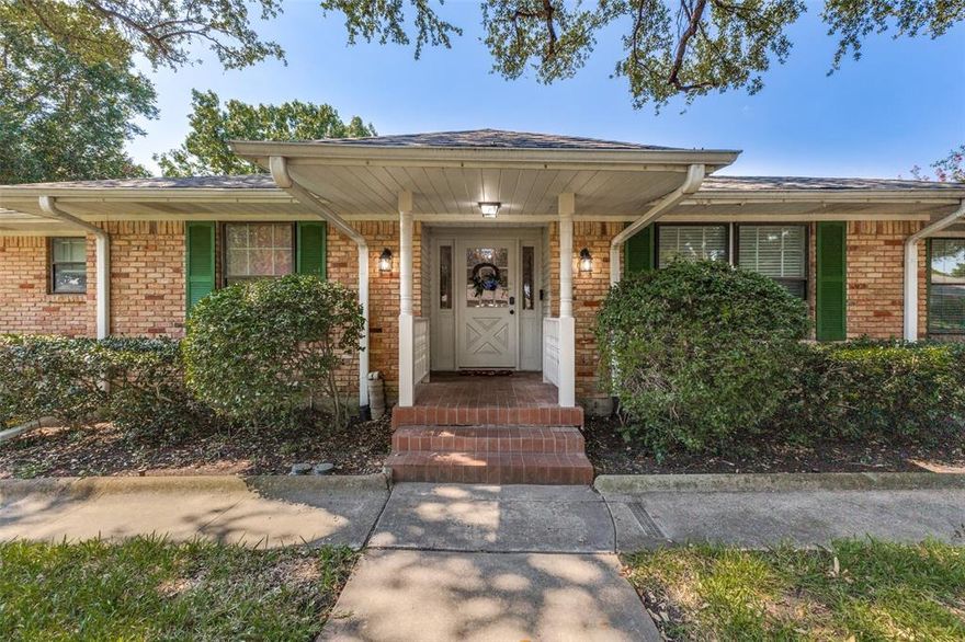 Welcome to a true Mid-Century Modern gem nestled on a spacious, shady lot in one of the area's most sought-after neighborhoods! Located within walking & biking distance to schools, churches, shopping & entertainment, this home offers both style and convenience. From the moment you arrive, you’ll be captivated by the majestic shade tree & welcoming front porch—a perfect spot to relax and connect with neighbors. Step inside to an expansive foyer adorned with original travertine tile, setting the tone for the thoughtful design & preserved architectural details found throughout. Just off the entry, a flexible formal space—currently a game room with billiards table—can serve as elegant living & dining areas. The inviting family room is anchored by a stunning, wall-to-wall brick fireplace with new gas logs, creating a dramatic focal point. The renovated kitchen is a tasteful blend of timeless & modern: Turkish bullnosed granite countertops, rich cabinetry, slate flooring, stainless steel appliances, pantry & sunny breakfast nook. Adjacent, a full-size laundry room with half bath add practicality to the charm of this space. Retreat to the spacious primary suite, large enough for a king-sized bed, with generous closet space & private access to the enclosed rear porch. The ensuite bath has been beautifully updated while honoring the home’s roots. Three additional bedrooms provide flexible living, office, or guest space. Throughout the home, you'll find original hardwood flooring, vintage tile & fixtures, beautiful molding & authentic ceiling treatments that showcase true MCM craftsmanship. Step outside to your own backyard oasis—perfect for gardening, pets or play. Don’t miss the incredible detached workshop featuring concrete foundation, screened-in porch, 110 & 220V electric, built-in workbench and shelving—ideal for hobbyists, crafters, or creative kids! This home is the Mid-Mod dream you've been waiting for—filled with character, updates, and one-of-a-kind charm.
