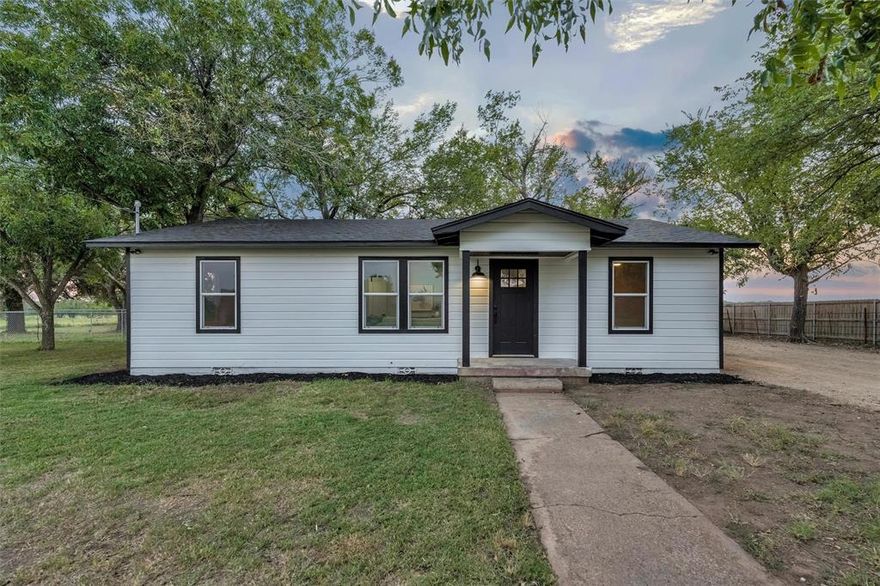 Taken down to the studs and thoughtfully rebuilt, this modern farmhouse blends timeless design with the comfort and freedom of country living. Featuring 3 bedrooms and 2 bathrooms, the home was carefully designed to feel warm, functional and inviting, with a layout that supports both everyday living and entertaining. The kitchen serves as the heart of the home, offering a generous island, custom cabinetry and quality finishes that balance style and practicality. Open living spaces are filled with natural light and views of the open land and wide Texas skies. Evenings bring remarkable sunset views, creating a peaceful setting that feels removed from the pace of city life. Situated on nearly 2 acres, the property provides space and flexibility for a variety of uses, including gardening, a workshop, animals or simply enjoying the privacy and quiet of a rural setting. A spacious two car garage adds additional storage and functionality. Every major component of the home has been replaced, including roof, HVAC, electrical, plumbing, windows, appliances, sheetrock, cabinetry, doors and durable LVP flooring, offering the confidence and efficiency of a fully updated home. Designed for those seeking space, comfort and connection to the outdoors, this property offers a rare opportunity to enjoy refined interiors in an open and peaceful Texas setting.