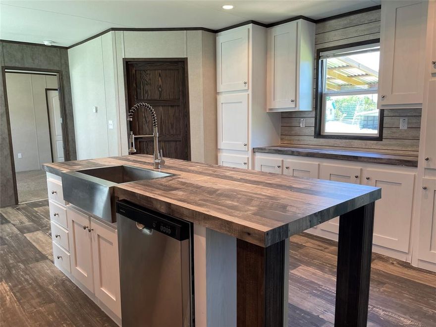 Big half acre corner lot just blocks from the courthouse square in Fairfield.  Practically new 2023 16x76 Jessup Mobile Home with covered decks on front & back.  Island kitchen with tons of cabinets, gas cook stove, vent-a-hood, SxS refrigerator, & dishwasher.  Kitchen is open to the living room & sunny table area.  Split bedrooms.  Primary with ensuite bath, double sinks, soaking tub, separate shower, walk-in closet.  Hall bath with tub & shower combo.  Laundry room will accommodate a full size washer & dryer.  Back door access to the covered deck. No Deed Restrictions.  Big front & back yards.  There are several mature trees and a kid’s clubhouse on the property.