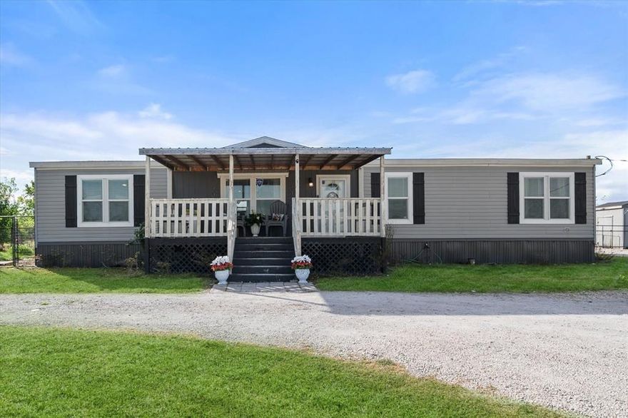 Cute country living meets everyday functionality in this move-in ready 4-bedroom, 2-bath home situated on a fully fenced 1-acre property. Designed with versatility in mind, this property is already set up for livestock, 4H or FFA projects, or hobby farming—making it truly ready from day one. The acreage features no-climb horse fencing with a gated entry, three spacious livestock pens (approximately 50x100 each) with direct water access, three storage sheds, a loafing shed, and flexible space ideal for feed storage, a tack room, workshop, or even a man cave or she-shed. A 6-person concrete tornado shelter adds peace of mind, while the large driveway offers ample space for RV or camper parking and multiple vehicles. Inside, the home boasts a spacious open-concept layout with rustic charm throughout, including a large living area perfect for gathering and an oversized kitchen with an island and stainless steel appliances. The private primary suite features an ensuite bath, while the additional bedrooms are generously sized with walk-in closets and share a second full bath. A dedicated utility room enhances everyday convenience. Enjoy relaxing on the 12x20 covered front porch or take advantage of the wide-open front and backyard spaces, already tailored for practical country living. Conveniently located just off a major highway, this property offers easy access while maintaining a peaceful rural setting—an ideal blend of comfort, space, and functionality.