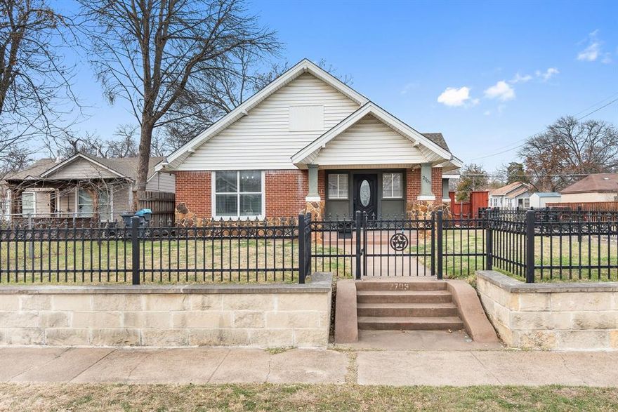 Welcome to 2703 Gladstone Drive, a beautifully updated Neoeclectic home situated on a spacious corner lot in the heart of Oak Cliff. This 3-bedroom, 2-bath residence offers 1,494 sq ft of thoughtfully designed living space blending timeless character with modern upgrades.
Original hardwood floors, arched doorways, 8-inch baseboards, and abundant natural light create a warm, inviting atmosphere throughout. The living room features a charming fireplace and flows seamlessly into the dining area and updated kitchen with stone countertops, double sink, white cabinetry, and stainless appliances. Appliances to convey include washer, dryer, refrigerator, and microwave.
Improvements include a new HVAC system, new foundation, double-pane windows, and updated bathrooms — providing peace of mind and move-in-ready comfort. Charming guest home with its own living space and kitchen, perfect for Airbnb or supplemental rental income. Outside, enjoy a 27-ft gated driveway with automatic gate, stone retaining wall, lush corner garden, gazebo, and expansive backyard ideal for entertaining or relaxing. Ideally located within walking distance to Moss Park, schools, and grocery stores, and just a 5-minute drive to the vibrant Bishop Arts District. This is a rare opportunity to own a beautifully maintained home with charm, space, and unbeatable convenience.