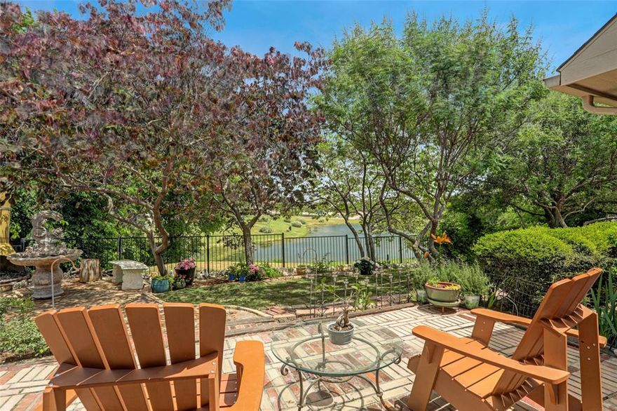 A rare find – this former model home was built on the best lot in the neighborhood with envious views of the pond and St Gabriel’s Catholic Church sanctuary.  Like living in your own private park, windowed walls provide spectacular views from the living area, kitchen, and master bedroom, adding natural grace to this home’s environment.  The back yard is a wooded oasis where you can watch ducks, herons, and other birds from the large patio, with a fireplace to make it cozy in cold weather. This well cared for one and a half story features an open and desirable floor plan with 3 split bedrooms, a separate office, large living room with soaring ceilings, up-stairs bonus room with half-bath, eat in breakfast and formal dining room.  Open granite kitchen boasts ample storage with solid 42- inch cabinets, freestanding double oven, and large window ledge.  Living area with engineered hardwoods, upgraded moldings, decorative wood burning fireplace with gas starter, travertine floors, and large format tiles in all the wet areas.  Master bedroom hosts oversized wall of windows overlooking private lake, upgraded master bathroom with separate vanities and huge walk-in closet.  The outdoor green-space hosts some of the best and the most tranquil landscaping available on the market.  Relax and enjoy the breeze coming off the water while watching herons catch a fish or catch one yourself!   Savor your coffee out back watching the sunrise or an evening meal under the oversized front patio.  You are covered and relaxed from East to West.  If you enjoy outdoors and relaxing in a peaceful environment, this home offers the perfect retreat.  Proximity to Frisco and Prosper makes it ideal for entertainment, shopping and dining.  Close to some of the best jogging and biking trails, tennis and pickleball courts, Apex center and sporting fields.  Truly a piece of paradise in the perfect location.  One-of-a-kind properties like this are rare.  Schedule a showing today!