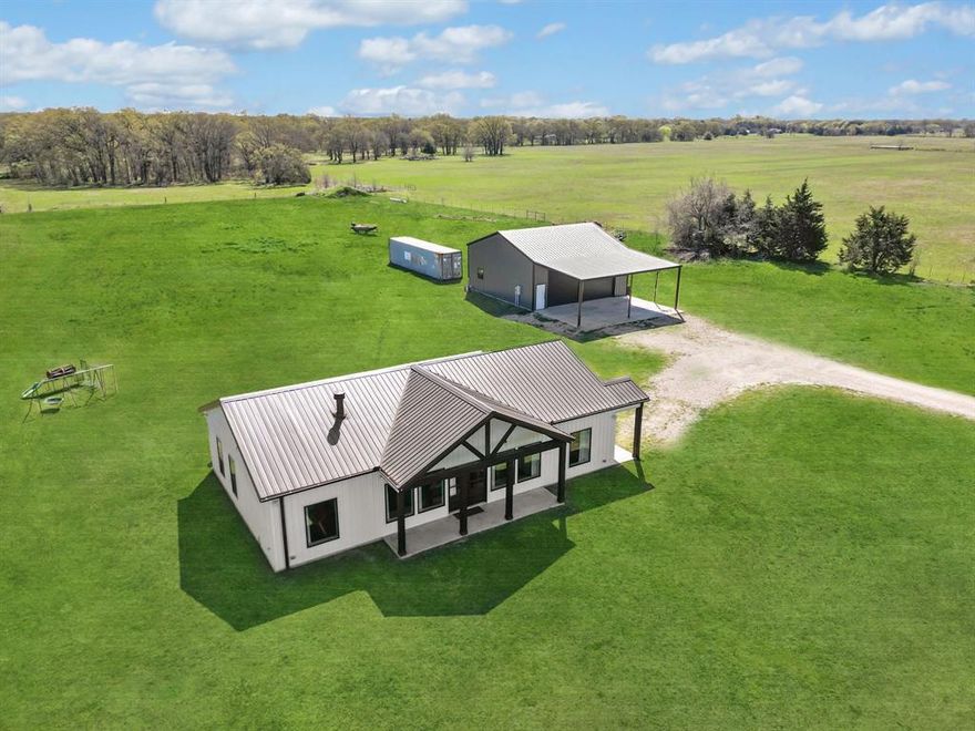 Don’t miss the opportunity to own this 14.77-acre AG Exempt property located in the desirable Club Lake area of Lone Oak and in Lone Oak ISD. Fully fenced and ready for your vision, this property offers the perfect space for a horse ranch, gardens, or a small farm. The charming modern farmhouse is better than new, with every detail thoughtfully considered by the owner. A welcoming front porch and double doors greet you as you enter the home, where soaring ceilings throughout the family room and kitchen create a bright and airy atmosphere. The kitchen features an oversized quartz island, ideal for entertaining, and is equipped with double ovens, a cooktop, and a farmhouse sink. The family room centers around a floor-to-ceiling brick fireplace, perfect for cozying up on chilly evenings. The primary bedroom includes a door leading to the back of the property, an ensuite bathroom with an oversized tub and shower, and a spacious walk-in closet. The two secondary bedrooms each have a bathroom conveniently located next to them. The exercise room offers a versatile space that could be used as a home office or craft room. The 35 x 35 shop with a 20 foot overhang is a dream for any craftsman, complete with separate living quarters that include a living room, bedroom, full bath, and kitchenette. The shop also has its own hot water heater and 2-ton HVAC system, as well as two insulated 12x12 pull-through garage doors—perfect for storing an RV or boat. The home is also incredibly energy efficient with 2 x 8 studs and spray foam in all the walls.  Located just minutes from Club Lake (shares may be available for purchase), this home is a must-see. Additionally, there is an option to purchase an extra 2.77 acres with a pond.