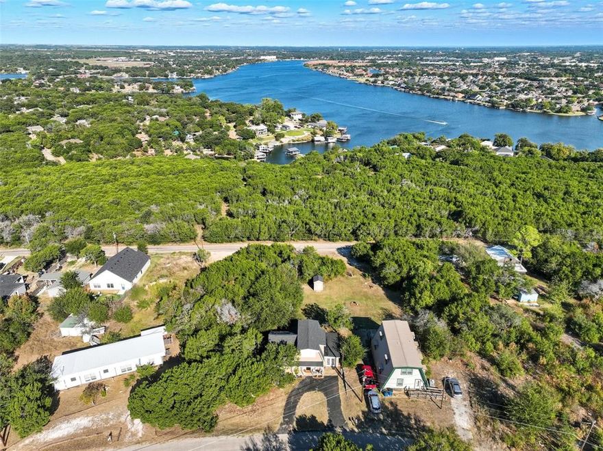 Enjoy peaceful lake views from this hilltop home overlooking Lake Granbury! Sitting on four spacious lots totaling over a half acre, this property offers room to expand and plenty of outdoor space. Relax on the balcony with your mourning coffee while watching the water shimmer below. Perfect for anyone seeking a quiet lakeside lifestyle, just minutes from shopping a Historic Downtown Granbury.