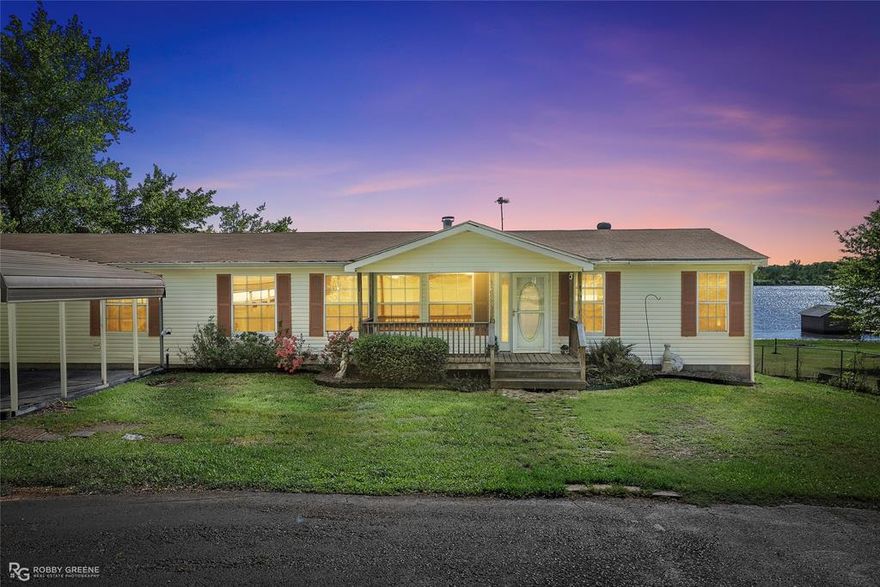 Discover the perfect lake retreat or full time residence with this custom built home offering peaceful waterfront living and panoramic lake views! Thoughtfully constructed with 2x6 walls and retrofitted for durability and comfort, this spacious property is ideal for lake lovers, fishing enthusiasts, or anyone seeking a serene escape.

Enjoy a cozy yet open floor plan featuring a generous living room with a wood burning fireplace that flows seamlessly into the kitchen and sunroom. The sunroom is a standout space with stunning lake views; perfect for sipping morning coffee or unwinding in the evenings. The kitchen is designed for functionality and style, offering ample cabinetry, a center island with eat-in bar top, and appliances included.

The flexible 4th bedroom, located just off the den with charming French doors, could serve as a home office, dining room, or guest space. The large, remote primary suite includes an ensuite bath with separate tub, shower, double vanities, and a spacious walk-in closet. Two additional bedrooms offer generous closet space and share a well-appointed hall bath with a tub-shower combo.

Additional features include a large utility room with space for two upright freezers, a utility sink, and a convenient side entry. Outdoor living is a dream here...relax on the welcoming covered front porch or entertain on the spacious back porch while enjoying the scenic setting.

With approximately 80 feet of road frontage, 119.5 feet of lake frontage, and deep lot dimensions of 489.5 ft on the east and 544 ft on the west, there is ample space to enjoy privacy and the beauty of the outdoors. Whether you're seeking a permanent home or a weekend getaway, this property offers the ideal blend of comfort, function, and lakefront charm.

Schedule your showing today and make your lake life dreams a reality!