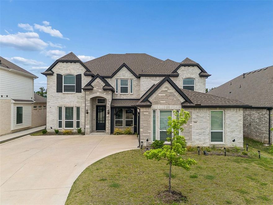 Beautiful semi-custom home on an oversized lot backing to a walking trail and park—offering both privacy and scenic views. The upgraded elevation features a charming covered front porch and a spacious covered back patio, perfect for outdoor living.
Inside, the home offers a thoughtfully designed layout with a private study, game room, and media room, along with formal living and dining areas. A stunning curved staircase creates an elegant focal point as you enter.
The kitchen is equipped with stainless steel Electrolux appliances, an oversized island with upgraded countertops, ceiling-height cabinetry, and a sleek stainless steel vent hood—ideal for both everyday living and entertaining.
Luxury vinyl flooring runs throughout all main living areas. Additional features include an EV charging outlet in the garage, a central vacuum system, tankless water heater, water purification system, and energy-efficient windows with a built-in security system.
The home is fully equipped with a HomePro security setup, including two control panels, front and rear cameras, and a Ring doorbell. Pre-wiring for sound is installed in the office, primary bedroom, bathroom, game room, media room, and patio, making this home both smart and entertainment-ready.