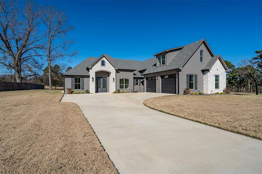 This gorgeous brand-new home offers over 3,000 square feet of sleek, clean traditional design with modern touches throughout, ideally located in sought-after Bullard ISD and minutes from both Bullard and Tyler. Situated on a spacious half-acre lot near Eagles Bluff Country Club and Lake Palestine, the home features an open floorplan filled with abundant natural light, perfect for both everyday living and entertaining. The generous dining area flows seamlessly into the family room, highlighted by a stunning stone fireplace with painted brick accents that coordinate beautifully with the exterior, along with custom built-ins. The kitchen is a showstopper with quartz countertops, a large island, pot filler, gas cooktop, black stainless appliances, custom cabinetry with some glass-front doors, pendant lighting, and a walk-in pantry. Luxury vinyl plank flooring and tile runs throughout the home, complemented by a dedicated office with French doors and a convenient half bath. The split primary suite offers a spa-like retreat with separate vanities, a freestanding soaking tub, walk-in shower, water closet, and an oversized walk-in closet. One guest bedroom features an ensuite bath, ideal for a mother-in-law suite, while two additional guest rooms share a full hall bath, providing ample space for family or friends. Additional highlights include a large two-car garage, laundry room with space for an extra refrigerator or freezer plus storage, sprinkler system, foam insulation, and a bonus flex space upstairs complete with mini-split, walk-in closet, and water line in the wall for a future bathroom—perfect for a fifth bedroom, media room, home gym, craft room, or man cave. Don’t miss this opportunity to enjoy East Texas and all it has to offer. *Option to buy into Eagles Bluff amenities!*