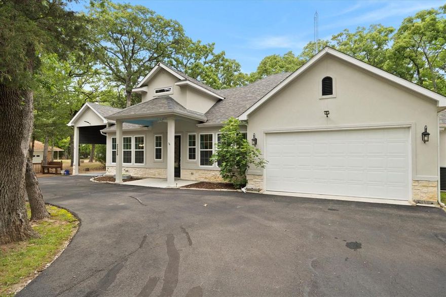 Nestled among towering trees in a peaceful, private neighborhood just moments from the lake, this beautiful home offers the perfect blend of comfort, nature, & convenience. A covered front porch welcomes you, while the circular drive & RV covered parking provide ample space for vehicles, guests, & outdoor gear. Inside, you’ll find a spacious open-concept layout filled with natural light from walls of windows that bring the outdoors in. The modern kitchen is a chef’s dream, featuring custom hardwood cabinetry, expansive granite countertops, and upscale stainless steel appliances—all overlooking a warm and inviting dining area ideal for gatherings. Expansive family room opens onto dining area and kitchen. The owner’s retreat offers a generous bedroom with a cozy sitting area and access to a spa-inspired ensuite bath. Two additional bedrooms with roomy closets share well-appointed full baths, providing comfort and flexibility for family or guests. A thoughtfully designed laundry room includes drip-dry rods and a full-size washer and dryer. Step outside to your private deck with firepit, where you can relax under the trees and enjoy frequent visits from local wildlife. With a 2-car garage, RV covered parking, & abundant outdoor space, this property is perfect for adventurers and those who love the lake lifestyle. Whether you're seeking a weekend escape or a full-time residence, this home delivers the best of lake and country living.
