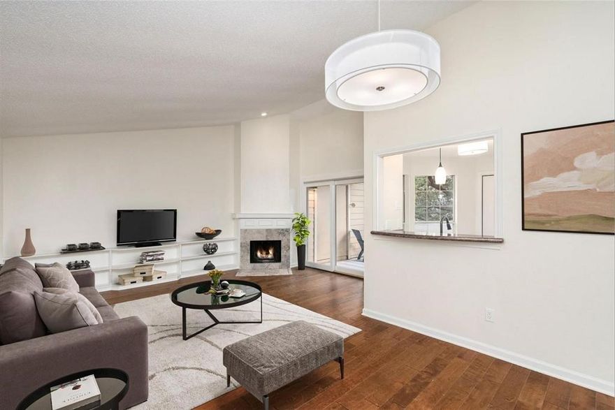 Motivated seller! Ask about 1% down payment options and potential assistance with closing costs.
Perfect for first-time buyers, this updated second-floor condo offers an open floor plan with a bright and spacious feel. The large living room features a vaulted ceiling, cozy wood-burning fireplace, and custom built-in bookshelves—ideal for everyday living or entertaining. Enjoy the convenience and privacy of your own private staircase leading directly to the unit, offering a unique entrance not shared with neighboring condos. Step outside to the covered patio overlooking the community pool, shaded by mature trees, with a private exterior storage closet included.

The kitchen includes granite countertops, a deep sink, and a breakfast bar that opens to the dining area, with the refrigerator included. A separate laundry room with built-in cabinets provides extra storage and functionality. The primary bedroom is generously sized with two closets, including built-in drawers, and features a light and bright ensuite bathroom.

Engineered hardwood flooring runs throughout for a modern, low-maintenance lifestyle. Assigned covered parking is included, and HOA dues cover water, sewer, and trash—helping keep monthly costs predictable. Community amenities include a swimming pool, scenic pond with dock, and walking trail. Conveniently located near I-635 and the Dallas North Tollway, with easy access to Addison’s shopping, dining, and entertainment.