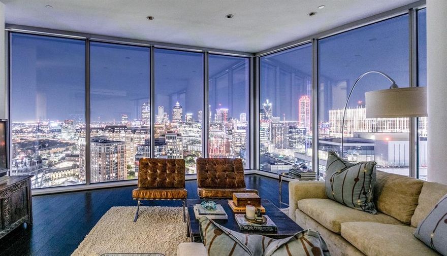 Rare sub-penthouse at the iconic Azure w both sunrise & sunset views as seen through oversized 11ft floor to ceiling windows.This open floor plan smartly displays the Dallas skyline ranging from east of FairPark all the way west to the Virgin Hotel offering breathtaking views. The living area is spacious & well-suited for entertaining w easy access to both of the outdoor living terraces featuring cozy gas fireplaces. The handsome kitchen is well-appointed & conveniently adjacent to the dining area featuring its own fireplace & overlooking the luscious views of the DesignDistrict, Calatrava Brdg, Am Airlines & the vast landscape west. Both bedrms have ensuite bath w full tub, separate shwr, lrg vanity & walk-in closets in addition to access to the separate terraces. Primary bedrm includes a separate fireplace, dual entry doors into the bath area & a custom closet design. Electric shades, two lrg hall closets, full utility rm & oversized 3 car enclosed garage complete this amazing home.