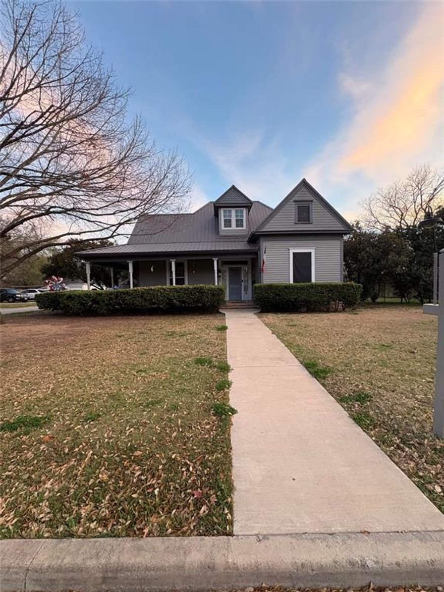 Step into timeless charm with this 3-bedroom, 2-bath home built in 1893 on a spacious corner lot. Solid bones and historic character you simply can’t replicate with modern construction. Major improvements including an upgraded HVAC system for year-round comfort and a durable metal roof installed in 2019. The solar panels added in 2017 to help maximize energy efficiency. The home has also been replumbed with PEX, offering reliability and long-term value. The third bedroom upstairs includes an attached bathroom space that could easily be finished out, creating the opportunity for a full three-bathroom layout. Relax and unwind on the covered back porch with added privacy, creating a peaceful space for grilling, or simply enjoying quiet evenings outdoors. Additional features include a dedicated tool room — perfect for hobbies, projects, or extra storage — along with a small outdoor shed ideal for lawn equipment or seasonal items.