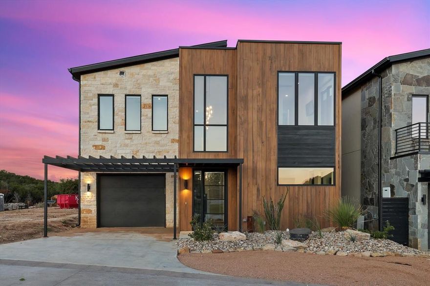 Step into modern lake living with this stunning 5 bedroom 3 and a half bath retreat at Possum Kingdom Lake. Designed with a sleek blend of stone and wood, this home offers both style and comfort from the moment you arrive. The floorplan is filled with natural light thanks to walls of windows that frame beautiful lake views and create a seamless flow between indoor and outdoor living.

The gourmet kitchen features quartz counters, stainless steel appliances, and an oversized island that opens to the dining area and living room. A stone fireplace adds warmth and style while the expansive glass doors lead to a spacious outdoor patio with a pergola, the perfect spot for grilling, entertaining, or just soaking in the views.

Inside, the layout was made for gathering. The large bunk room provides plenty of space for guests while each bedroom offers comfort and privacy. The primary suite boasts a spa style bath with modern finishes and incredible views. With multiple living spaces and thoughtful details throughout, this home is ideal for both full time living and weekend getaways.

The upstairs balcony is a true highlight, offering lake views and gorgeous sunsets. Relax with friends by the fire table, grill out under the pergola, or simply enjoy the breeze coming off the water.

Located in Juniper Ridge one of the most desirable communities on the lake, you are just steps away from the water and all the activities Possum Kingdom is famous for. Whether you are looking for a family retreat, a place to entertain, or a home with excellent rental potential, this property delivers on every level.