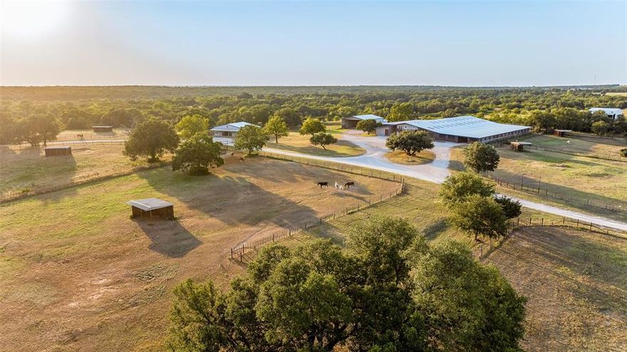 Masterfully planned 105 acre equestrian estate with indoor arenas, high capacity stall barn, stud barn, multiple apartments, scenic land, & 2 homes. Massive income potential combined with picturesque surroundings. Indoor arenas set amidst established oaks under a 120’x220’ building, 16 stalls, tack, & elevated office. Stud barn ensures utmost safety with concrete stalls, separated runs, tack, & wash rack. Stall barn boasts an astounding 84 head capacity & a comprehensive veterinary facility. Outdoor amenities include a lighted arena, round pen, over 20 turnouts with cover, & an alley system. Automatic water throughout the property. Majestic oaks & established trails enhance the scenic beauty along with a split of Grub Lake. Excellent water storage in place via wells & lake pump. Multiple equipment sheds, hay and shaving storage. Primary home is 2561 sqft., 3 bed, 2 bath, with a bonus room. Secondary home is fully renovated with 3 bed, 2 bath. Additional details available upon request.