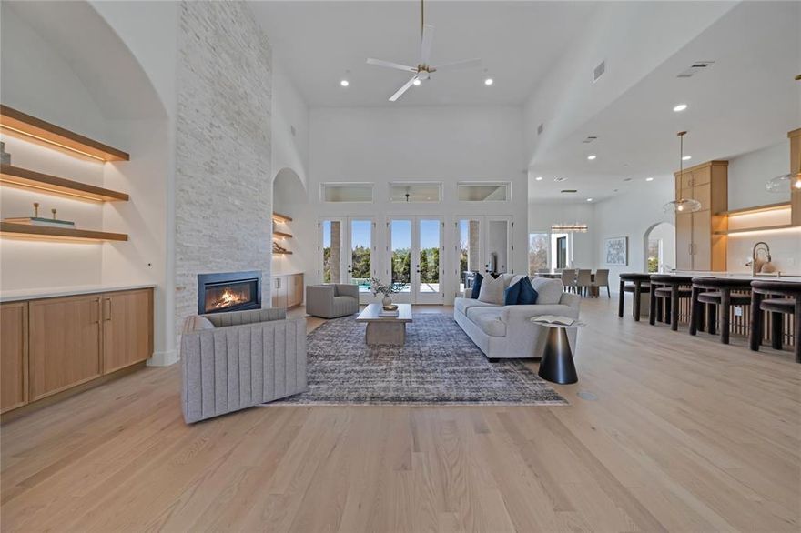 Best-Priced New Construction in Ridge Lakes – Now Under $2M. This completed, exceptional, single-story estate offers 4,808 square feet of thoughtfully designed luxury on an expansive .65-acre lot, blending refined craftsmanship with modern sophistication. Featuring four bedrooms, four and a half baths, and a rare four-car garage, the home is tailored for both elegant entertaining and everyday comfort. Upon entry, soaring 18-foot ceilings in the foyer and great room create a dramatic first impression, complemented by 12-foot ceilings throughout the rest of the home. Natural oak hardwood floors flow seamlessly through the living spaces, while custom white oak cabinetry, Italian tile selections, and Venetian plaster finishes showcase impeccable attention to detail. The gourmet kitchen is a true centerpiece, highlighted by a striking quartz waterfall island and counters, luxury appliances, and designer lighting. Dedicated spaces include a private office, a fitness room or second office, a formal dining room, and a media room complete with a wet bar—perfect for hosting gatherings. The primary suite is a private retreat featuring 13-foot LED tray ceilings, elegant arched vanities, a spa-inspired rain shower, and an expansive dream closet. Designed for modern living, the home is smart-home ready and prewired for whole-home audio, security cameras, and WiFi access points. Outdoor living is equally impressive with a covered patio showcasing an outdoor fireplace and kitchen, all overlooking a custom pool with a tranquil waterfall feature—an ideal setting for relaxation or entertaining year-round. $25,000 builder credit when using preferred lender. Rates as low as 4.99%.