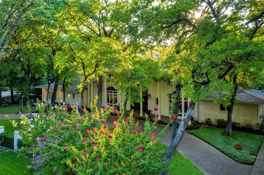 Lush one-acre residence in Preston Hollow sits on an idyllic creek and is ready for renovation or new build. The grand staircase in the entry, expansive living and dining areas, step-down bar, and generous kitchen complete with separate catering area make this home perfect for entertaining. A first-floor gallery leads to a private primary suite featuring a large bedroom, separate living area and his-and-hers ensuite baths. There are three bedrooms and a privately accessed two-bedroom suite with sitting area on the second floor. The home offers multiple parking pads, a two-car garage, a basement, and an elevator that spans three floors. The salt-water pool features a waterfall and a cabana with two baths. Two accessory buildings are ready to be finished out as additional office, entertaining, or guest spaces. Large, wooded areas and hardscape overlooks in the backyard have amazing views of the creek.