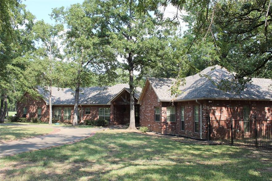 Spacious single story home in heavily treed and gated community. Home is nestled on two lots with towering trees and has elbow room! Sprawling floor plan includes 2 separate living areas, huge living area with fireplace & vaulted ceilings, well-appointed kitchen with island, spacious bedrooms and large 3 car garage. Located on peaceful cul-de-sac street.