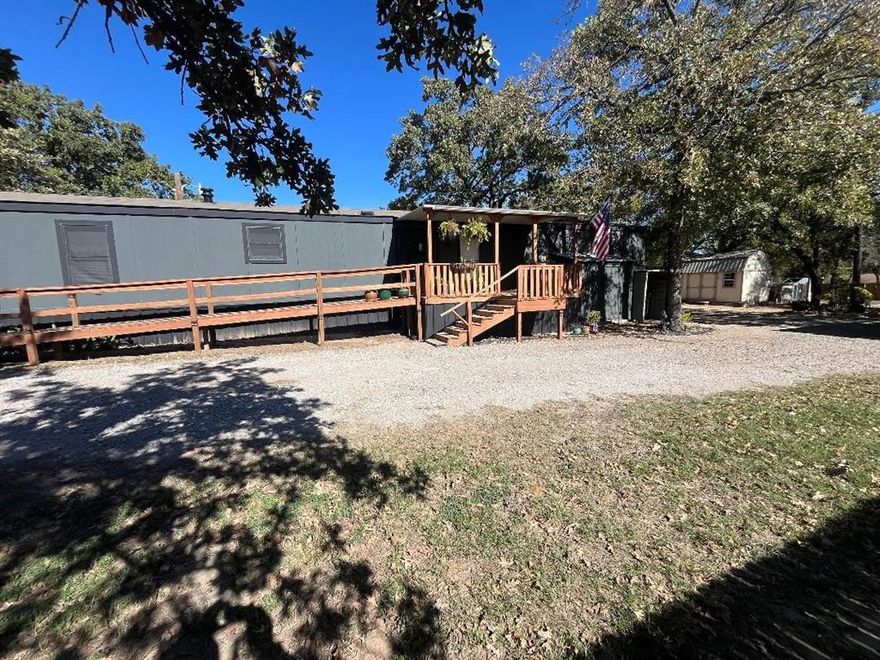 COME AND SIT A SPELL ON THE TREE SHADED FRONT PORCH.  Additional photos will be coming once moved, nice home ready for you! This home is just a short 5 minutes to Azle or just 35 minutes to downtown Fort Worth.  If you are looking for a starter home, investment property or final home, this is a must see. 2 storage buildings for your toys and equipment, almost an acre of land to enjoy.   A great blend of modern living and wide-open space with manufactured home situated on just under an acre in charming Azle, TX. This move-in-ready home offers the peace and privacy of country living while still being conveniently close to shopping, dining, and schools. Inside, you'll find a bright and functional floor plan featuring an open-concept living, dining, and kitchen area—ideal for both everyday living and entertaining. The primary suite includes a large walk-in closet and a private bath. This oversized lot offers endless potential for a fabulous garden and extra room to roam. With no HOA and plenty of space to make it your own, this property is a rare find! Covered front patio is perfect for morning coffee or enjoying the evening air. Whether you're a first-time buyer, looking to downsize, or want more land to enjoy, this home checks all the boxes. Schedule your showing today!   Sellers are in the process of moving - so pardon our disruption! Buyer to verify all information.