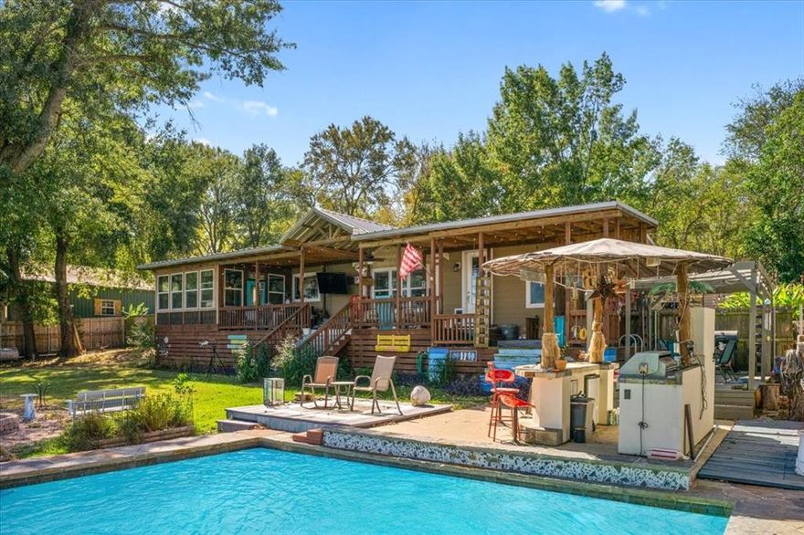 Discover lakeside living at its finest in this stunning 3 bedroom, 2 bath, 1,740 square foot home on beautiful Cedar Creek Lake. From the moment you enter, you're greeted by an open concept floor plan that flows seamlessly from the chef's dream kitchen into the spacious living area, where large windows frame breathtaking water views. The primary suite is a true retreat, featuring a large layout, a spa inspired bath with a separate shower, and a private room showcasing a relaxing garden tub. The split bedroom design ensures a lot of privacy. Perfect for entertaining, this property offers multiple outdoor spaces, including a screened in patio, sprawling covered front deck, and a cabana style setup complete with an outdoor kitchen. Enjoy the sparkling inground pool and hot tub just steps from the front porch. With no HOA and convenient access to local dining, shopping, and more, this lakefront property combines comfort, resort style living, and the perfect escape for those seeking both relaxation and luxury.