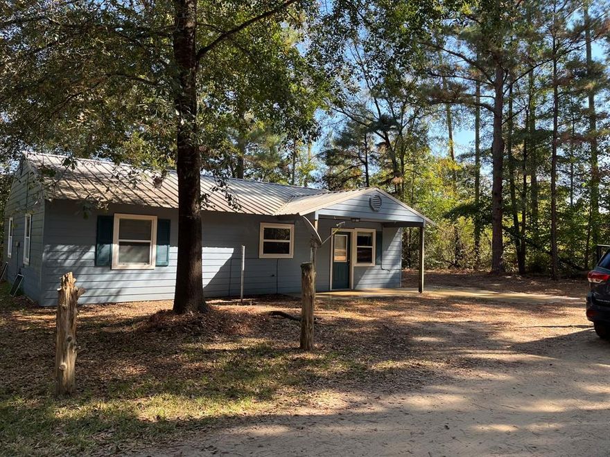 Peaceful Country Living Minutes from Lake Hawkins – Experience Every Season in Style! Escape to your own private retreat with this charming 3-bedroom, 2-bath home set on an acre, offering a perfect blend of natural beauty, privacy, and convenience. Surrounded by mature trees and scenic views, this property provides a peaceful sanctuary that changes beautifully with the seasons. Step inside to discover spacious, open living areas and a comfortable layout designed for everyday living. The primary suite offers a relaxing escape with its own private bath, while two additional bedrooms are ideal for family, guests, or a home office. Outside, you’ll love the covered porch, perfect for savoring your morning coffee or unwinding in the evening while soaking in the sights and sounds of nature. With an acre, this wooded property invites you to enjoy seasonal experiences year-round—from vibrant spring blooms and shady summer afternoons to colorful fall foliage and cozy winter walks. Located just minutes from beautiful Lake Hawkins, you’ll enjoy easy access to boating, fishing, swimming, and lakeside picnics, all enhanced by the ever-changing beauty of the seasons. Whether it’s summer fun on the water, autumn hikes under golden leaves, or peaceful winter mornings, this property offers a lifestyle that connects you to nature all year long. FHA AND VA APPROVED. Additional 2 adjoining wooded acres available for $15,000.