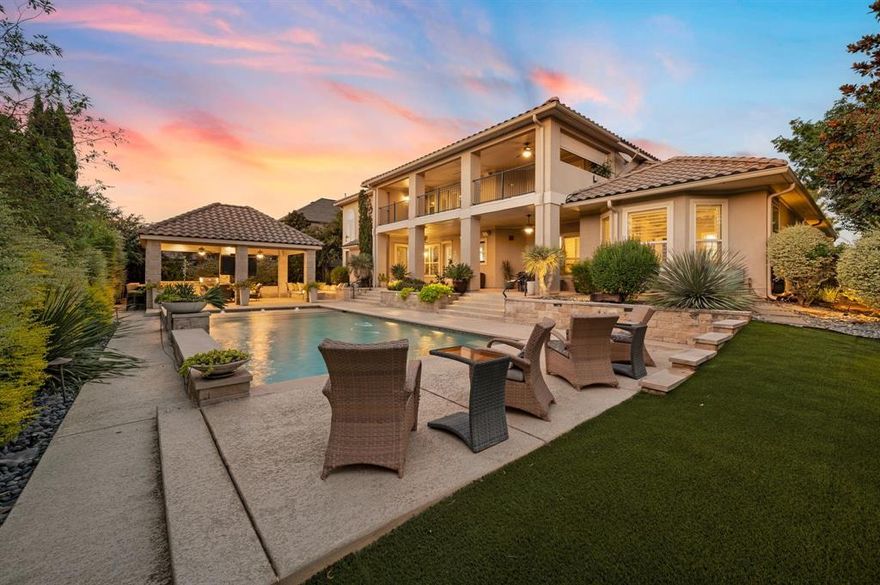 Welcome to this stunning Mediterranean-style home in the prestigious Reserve at Colleyville, where timeless elegance meets everyday convenience, just minutes from DFW Airport! From the moment you walk in, you’re greeted by soaring ceilings, sunlit rooms framed by walls of windows, and rich tile flooring that flows throughout. Custom designer lighting adds a warm, sophisticated touch, creating an inviting atmosphere in every corner. This thoughtful floor plan offers space for every occasion, featuring 5 generous bedrooms, 4.5 bathrooms, a private office, and a three-car garage with polished epoxy floors. Upstairs, a game room and media room with a wet bar and built-in HDMI system set the stage for movie nights and gatherings with friends and family. The chef’s kitchen is both stylish and highly functional, centered around a large granite island and surrounded by custom cabinetry with soft underlighting. Premium appliances—including a built-in refrigerator, steam oven, convection oven, and warming drawer—make cooking and entertaining a breeze. The primary suite is a true retreat, offering a spa-like ensuite with a jetted tub, walk-in shower, dual vanities, and two spacious closets. Step outside to your private resort-style oasis. A sparkling pool is the focal point of the backyard, complemented by a covered patio, balcony, and cabana. The outdoor kitchen, full dining setup, fire-lit lounge, and integrated mosquito system make this space perfect for year-round enjoyment and effortless entertaining. Every detail of this home is designed for luxurious living, where comfort, style, and convenience come together seamlessly. Just minutes from world-class shopping and dining, this property offers more than a home, it offers a lifestyle.