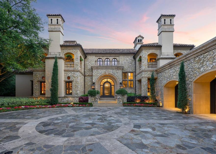 Rising behind a circle drive and flanked by Mediterranean cypress trees, 15 Robledo Drive evokes the timeless romance of a European villa. Within the gates of Los Arboles, Preston Hollow’s most exclusive enclave, the estate reveals itself like a scene from the Tuscan countryside — limestone cladding, ironwork arches, and a harmony of sunlit spaces. Originally designed by Robert Trown and recently updated by J.R. Cattington Interiors, the home balances Old World character with modern livability. Reclaimed oak floors and hand-hewn beams add texture, while arched openings and generous ceiling heights guide you from one light-filled room to the next. A richly paneled library, formal living and dining spaces, and a butler’s pantry lend themselves equally to both intimate moments and grand entertaining. The kitchen shines with custom millwork and veined stone, flowing into a cheerful breakfast nook, relaxed family lounge, and study. Across the home, eight fireplaces weave a unifying thread of warmth and elegance. The main-level primary suite feels like a private wing, complete with dual baths and boutique-style closets. Upstairs, two guest suites rival luxury hotels, each with its own fireplace and balcony. A fitness room, bonus space, and ample storage complete the second floor. Outdoors, the estate unfolds with equal composition and care: a waterfall-fed pool, lush gardens, pavilion, putting green, and a loggia with fireplace and kitchen — coming together to make everyday living feel exceptional. Control4 home automation, dual garages, and a private elevator ensure the home lives as effortlessly as it looks. 15 Robledo Drive offers a rarity in today's market: an updated home that preserves the soul of a classic estate.