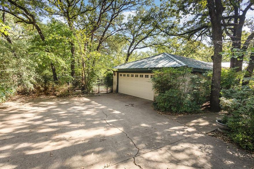 Rates just dropped and qualified Buyers can get another .5% off through our preferred lender or this home can qualify for a 2-1 year Buydown. Seller is willing to transfer mineral rights with a full price Seller accepted offer. Discover a charming 3-bedroom, 2-bathroom home that is tucked away yet close to everything, mins to AT&T stadium, Dallas, Fort Worth and DFW Airport. Escape the city with your own piece of paradise on this oversized lot home. Meander down the tree covered walkway to your front door.  Enter a  home has been recently updated with a 40 year metal roof, upgraded floors, newer HVAC and water heater and a gourmet kitchen. The kitchen is an entertainers delight. Beautiful black and gold granite countertops, an over sized sink, gas range and granite tile floors are just a few of the items that make this kitchen special. Both bathrooms have been updated with the primary having a huge walk in shower. This must see home is nestled in a convenient location, that offers easy access to local shopping, dining, and entertainment, along with nearby parks and recreation. Major highways are just minutes away, making commutes simple and weekends full of possibilities. Enjoy a backyard that provides serenity and seclusion, nature and peace.