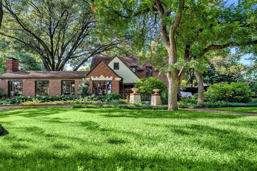 Prepare to swoon over this magical Tudor Revival, perfectly positioned on a lush half-acre overlooking Stevens Park Golf Course. Completely reimagined in 2017, this architectural gem blends historic charm with modern luxury, featuring a meticulously expanded & redesigned floor plan finished at the highest level. Step inside to stunning arched doorways, exposed wood beams, custom millwork & showstopping living area with breathtaking views. Relax in the cozy study, where original stained-glass windows, fireplace & custom bookshelves create an inviting retreat. The chef’s kitchen features imported LaCanche range, handcrafted cabinetry, quartzite counters & atrium windows showcasing a majestic oak tree. The first-level primary suite is a sanctuary offering a spa-quality bath with heated floors, designer lighting & expansive custom closet. Downstairs has guest suite plus a 2nd primary option, 4th bedroom & additional living space upstairs with serene patio. Outside enjoy large magnolias, Japanese maples & curated native landscaping that create a storybook setting. The front bluestone patio, formal gardens & rear terrace add European charm. Thoughtfully designed, this is a rare opportunity to own a special home in Stevens Park Estates!