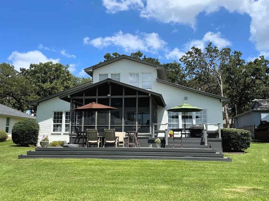 Looking for a lake home that has room for everyone? This property is the perfect fit! Featuring 3 bedrooms, 3 baths, 2 overflow sleeping areas, spacious upstairs that could almost be considered a 4th bedroom a spacious dining area, and a beautifully designed kitchen, it's ideal for gatherings. The boathouse, approximately 1 year old, offers deep water access, synthetic wood construction, a party deck, and PWC lift. Enjoy the stunning yard with explosive wide open water views, upper and lower wood decks, screened-in porch and open air outdoor shower to rinse off after enjoying the lake. This open-water retreat is ideal for year-round use. This is a fabulous opportunity to live on open water at an unbeatable price point!