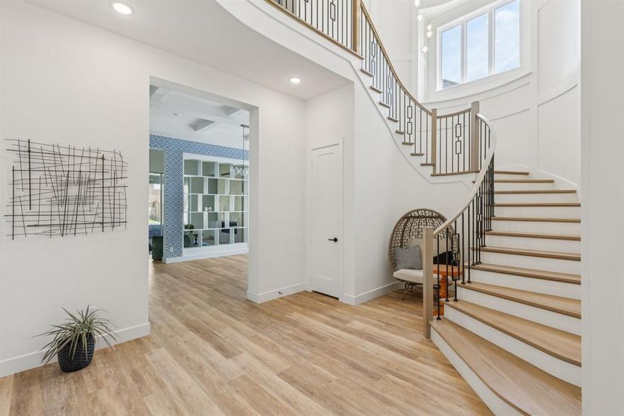 Priced to sell! Below market value!  Preferred lender pricing for Redfin listings. Contact me to find out the savings. Not your typical community home. This Highland Homes plan 817 is priced to sell and move-in ready, just in time to settle into Prosper ISD. Boasting over 5,000 sq ft, 5 en-suite bedrooms, 2 powder rooms, & standout custom upgrades, every inch of this home showcases thoughtful design & inviting warmth. An open foyer welcomes you in, with an elegant staircase framed by curved wall panels setting a graceful tone. Straight ahead, the open dining room is visually anchored by a two-way bookshelf that flows into a soaring living area with striking floor-to-ceiling tiled fireplace and a 4-panel retractable glass slider that blends indoor comfort with outdoor living. At the heart of the home is a chef’s kitchen with Quartz backsplash stretching above a custom hood, 48” built-in fridge, luxury appliances, soft-close cabinetry, gold hardware, & a custom side-by-side doggy den tucked beside the kitchen peninsula. The expansive covered patio is equipped with gas-line & ceiling plugs ready for future screens, all overlooking an 82’ backyard ready for a pool or recreational dream space.  Retreat to the spa-inspired primary suite with soaking tub, frameless steam-effect shower with Moen body jets, dual vanities, & a designer oversized LED-lit walk-in closet. Enjoy movie nights in the stylish media room, drinks in the game room with wet bar, & host guests in the downstairs suite with a beautifully tiled bathroom. Additional highlights include soffit ceilings, premium LVP flooring, custom lighting, walk-in pantry, attic storage, epoxy-coated garage, brick-paved driveway & walkway, abundant storage, & swing-ready porch beams. Live in award-winning Mustang Lakes with front yard maintenance, resort-style pools, state-of-the-art fitness center, basketball & tennis courts, stocked lakes, scenic trails, & a vibrant clubhouse