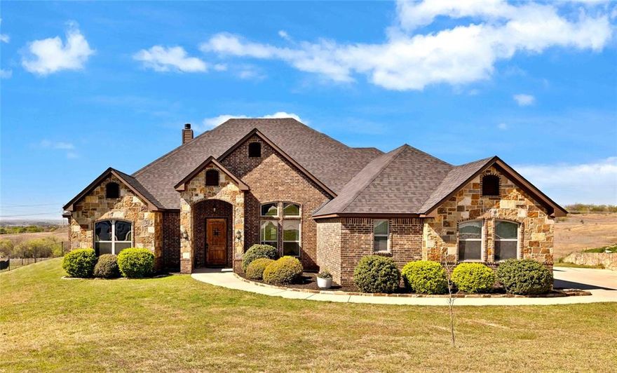 **ASSUMABLE VA LOAN for Veteran** Situated on a hilltop in the gated community of Lago Vista at Bonds Ranch, this beautiful one-story home offers the perfect blend of peaceful country living and modern convenience. Situated on over a full acre, the property boasts sweeping views, a sparkling pool, and an oversized covered patio—ideal for relaxing or entertaining. Inside, the open-concept layout is filled with natural light and anchored by a spacious living room featuring a cozy fireplace and stunning backyard views. The kitchen flows seamlessly into the living and dining areas and is well-appointed with granite countertops, a large island with breakfast bar, walk-in pantry, and built-in microwave. The thoughtfully designed split floor plan includes 4 bedrooms and 3 full bathrooms. The private primary suite offers a spa-like retreat with dual vanities, a soaking tub, separate shower, and a generous walk-in closet. The additional bedrooms are perfect for guests or multigenerational living—which share a full bath. The 3-car oversized garage and extended driveway provide ample space, including room for a boat. This home is loaded with upgrades and long-term value, including a TDI Impact Resistant Class 3 roof with transferable warranty, piered foundation and piered pool, spray foam insulation, and full Cat 5 wiring available to be set up for in-home sound and intercom system. Enjoy the best of both worlds—quiet, scenic living just minutes from Eagle Mountain Lake and the new Eagle Mountain High School, with easy access to major conveniences. Located just 25 minutes from downtown Fort Worth, 35 minutes from DFW Airport, and only 10 miles from Alliance Town Center with premier shopping, dining, and entertainment. Community amenities include gated access, fishing ponds, playgrounds, swimming pools, and walking trails. This is a rare opportunity to enjoy space, privacy, and high-end features—all within close proximity to the city.
