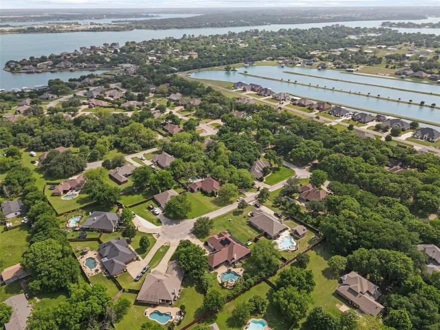 Welcome to your next energy-efficient, single-story brick home in the highly sought-after gated community of Timber Cove! Surrounded by mature trees and featuring access to a private community boat ramp, this home offers the perfect blend of comfort, privacy, and recreation. Inside, you’ll find four generously sized bedrooms and three full bathrooms, thoughtfully laid out to accommodate multigenerational living or anyone needing a private space of their own. A wing of the home includes its own entry door, living room, bedroom, bathroom, and kitchenette, offering flexibility for guests, in-laws, or independent family members. At the heart of the home is a large, inviting kitchen with painted cabinets, a center island, and a built-in desk, seamlessly flowing into the living room with its cozy corner fireplace—an ideal setup for gathering and entertaining. Step outside to your fully fenced backyard oasis, featuring a sparkling pool with spillover spa and lush landscaping for added privacy and beauty. There’s even driveway access to the backyard, allowing you to easily back your boat behind the fence—perfect for quick outings via Timber Cove's private boat ramp. Zero to super low electric bill thanks to solar! Seller will pay off solar panels with strong offer.  Conveniently located with easy access for commuters, this home offers an unbeatable combination of comfort, amenities, and lifestyle. Don’t miss the opportunity to make this exceptional property your own!