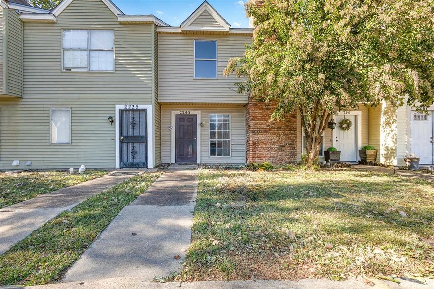 Welcome to this charming two-story townhome located in the well-maintained Village By The Creek community. This 2-bedroom, 1.5-bathroom residence offers approximately 915 square feet of comfortable living space. The main floor features an open-concept living and dining area with a cozy wood-burning fireplace, perfect for relaxing or entertaining. The kitchen includes an electric range, dishwasher, and refrigerator. Both bedrooms are situated upstairs, offering privacy and a functional layout. A fenced backyard provides an outdoor space for pets, gardening, or quiet enjoyment. Located near major highways, shopping, and dining.