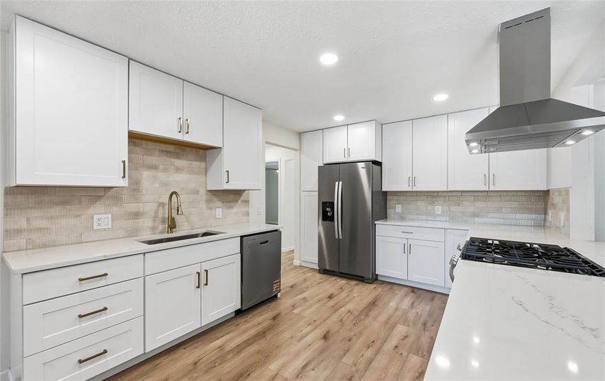 COMPLETELY RENOVATED SINGLE-STORY ON OVER A THIRD OF AN ACRE! This stunning home showcases a perfect blend of thoughtful design & sleek modern finishes, offering fresh paint, updated bathrooms, vaulted ceilings, oversized secondary bedrooms, a floor-to-ceiling brick fireplace, and a laundry room equipped for a stackable washer and dryer. Elevate your culinary game in the beautifully remodeled kitchen boasting quartz countertops, stainless steel appliances, white cabinets with modern hardware, a refrigerator, and gorgeous backsplash. Work comfortably from home in your office with built-in bookshelves, or end your day in the large primary suite graced with a dual sink vanity, semi-frameless shower, and a walk-in closet. Unwind in the light and bright sunroom, curl up with a good book on the cozy front porch, or host weekend barbecues on the covered patio. There’s ample room for parking with a circle driveway plus a spacious 2-car garage with abundant storage space. Other features include a recently replaced roof, HVAC unit, windows, light fixtures, ceiling fans, light switches and outlets, flooring, and interior doors. Close to plenty of shopping and dining options, including Allen Premium Outlets, with quick access to 75 and 121 for an easy commute. Take a first-person look at this gorgeous home! Click the Virtual Tour link to see the 3D Tour!