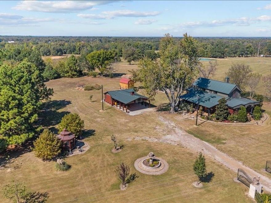 Welcome to a truly exceptional residence where heritage meets country charm and exceptional craftsmanship nestled on 14.5 acres in Emory, Texas. The history of this home goes back to the 1890’s when it was first built. In the 1970’s it was moved to this property and remodeled. In 2017 the current owners bought it and completely rebuilt it from the studs with all new electrical and plumbing. Throughout the home, thoughtful touches like antique hardware, intricate trim, and vintage lighting fixtures gives it a historical 1800s feel. With over 2800 sq.ft. in the main home, there is plenty of room for all. The primary bedroom is downstairs, along with the second bedroom (or office). The third bedroom, reading area + a loft is upstairs and there are a total of two and half bathrooms, two living areas and a formal dining. With intricately hand painted metal ceilings, vintage metal crown molding, original shiplap, antique lighting, vintage stain glass windows and incredibly detailed tile work you will simply never find another home like this. A limestone pathway will bring you around the home to the stunning landscaping and porches. The Carriage House sits just a ways from the main home and with a gorgeous covered parking area, game room, and RV Hook Up. This property is a perfect mix of pine trees and a fully stocked pond, perfect for a retreat and an opportunity to build guest cottages throughout the property leading to the pond. Schedule your private tour today to visit a place where the craftsmanship of a bygone era blends seamlessly with contemporary amenities, offering a living experience that is both rare and refined.